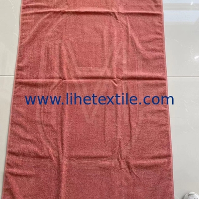 OEM custom luxury 100% cotton plain embossed  logo design beach towel with tassel